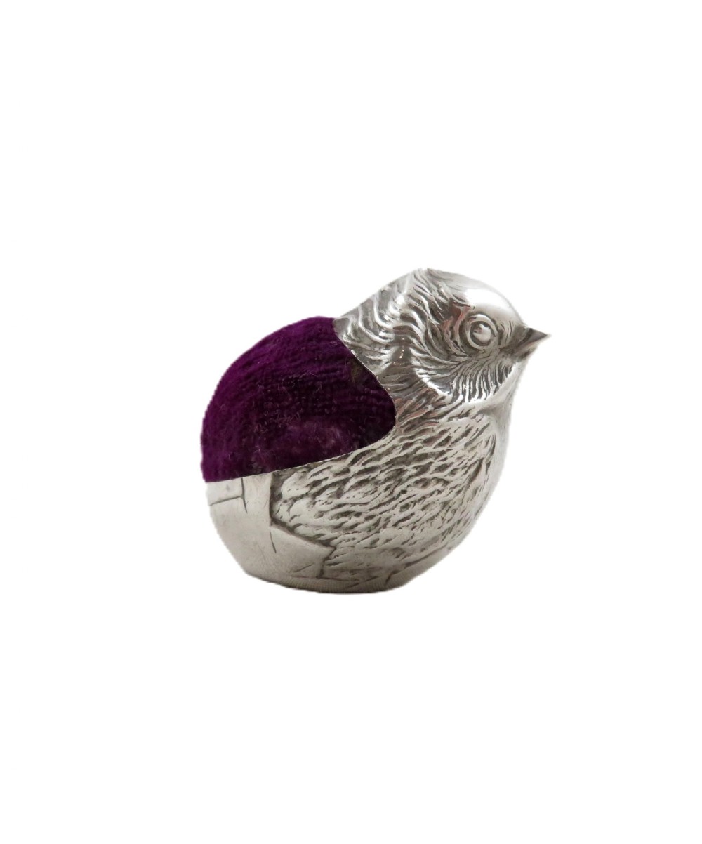 An Edwardian sterling silver pin cushion crafted in the shape of a chick with a purple velvet cushion inset into its back. View VII
