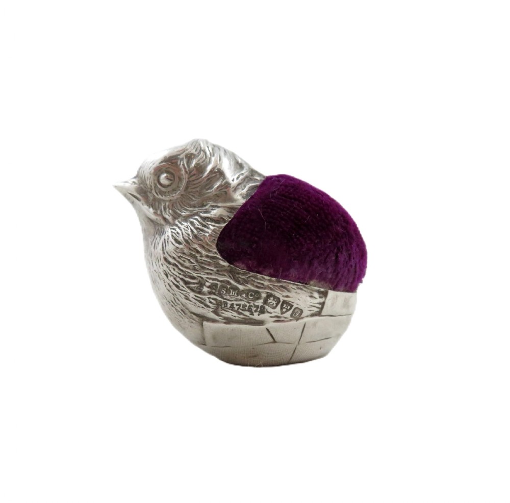 An Edwardian sterling silver pin cushion crafted in the shape of a chick with a purple velvet cushion inset into its back. View VIII