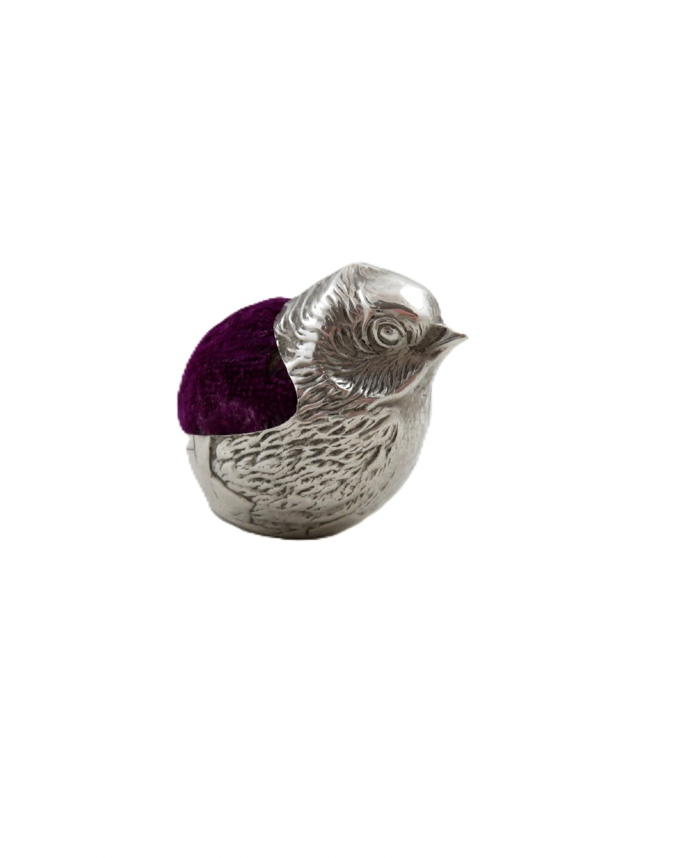 An Edwardian sterling silver pin cushion crafted in the shape of a chick with a purple velvet cushion inset into its back. View IX