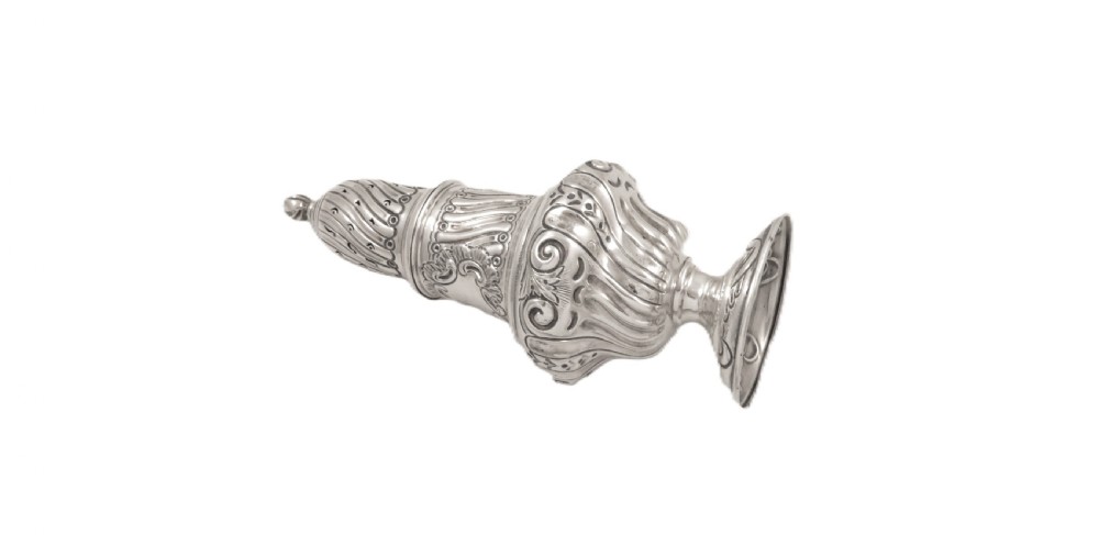 An Edwardian sterling silver sugar castor featuring a spirally fluted pierced dome lid, embossed scroll cartouche, and a turned pedestal foot. View VI