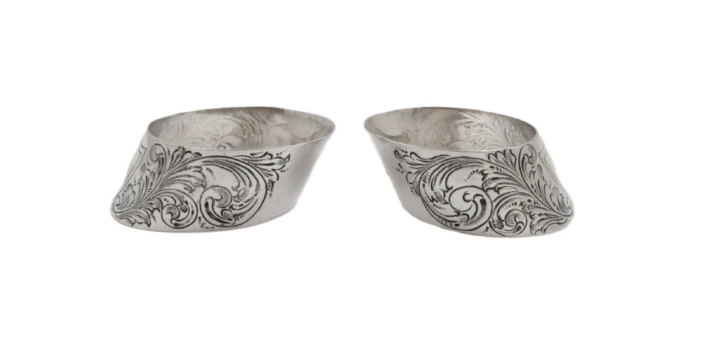 A pair of engraved Victorian sterling silver napkin rings set inside a red silk and velvet lined presentation box. View VI