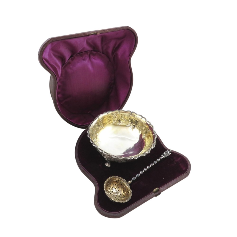 Victorian sterling silver sugar bowl with a matching pierced sifter spoon presented inside a velvet-lined fitted case.