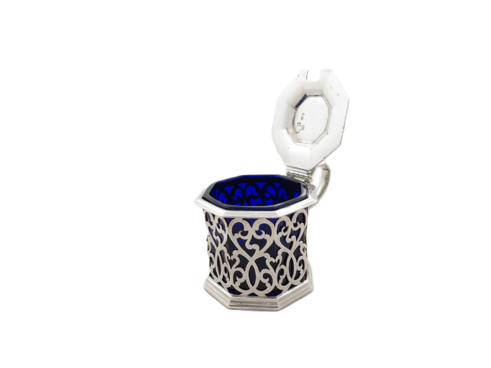 An octagonal Victorian sterling silver mustard pot featuring pierced scrollwork and a cobalt blue glass liner. View III
