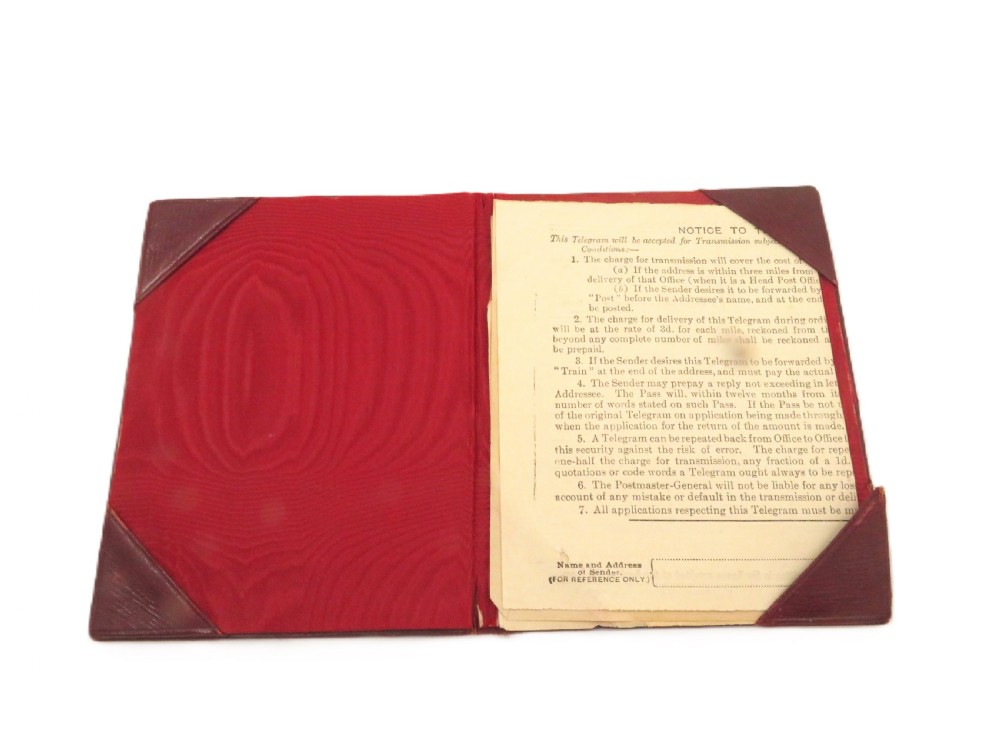 An Edwardian sterling silver telegram folder cover featuring relief scrollwork, floral motifs, and embossed lettering reading Telegrams. View III