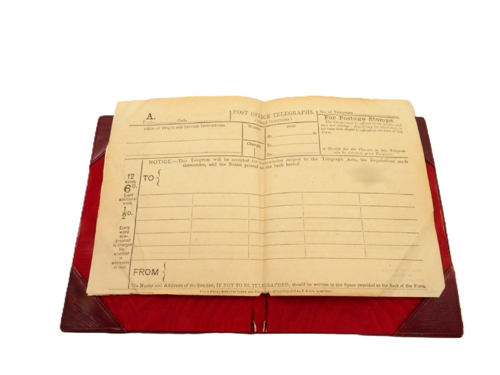 An Edwardian sterling silver telegram folder cover featuring relief scrollwork, floral motifs, and embossed lettering reading Telegrams. View VIII