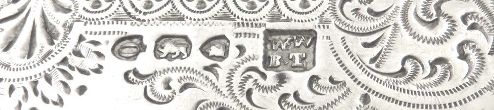 A Victorian sterling silver knife and fork set with engraved foliate patterns displayed inside an open black velvet-lined presentation case. View VII