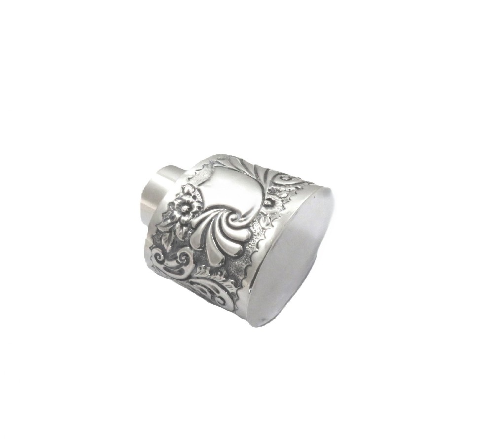 An antique late Victorian sterling silver tea caddy featuring repousse floral scroll decoration and a smooth fitted cap lid. View VI