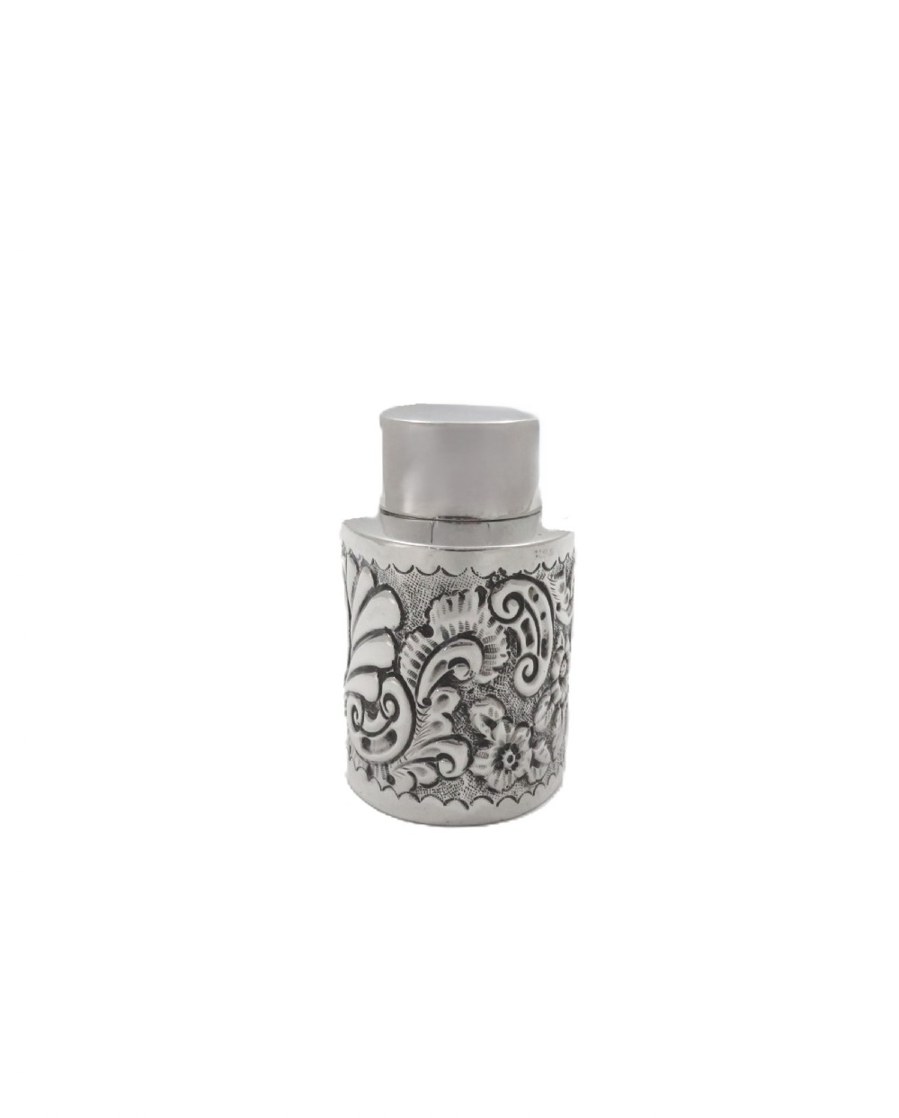 An antique late Victorian sterling silver tea caddy featuring repousse floral scroll decoration and a smooth fitted cap lid. View VIII