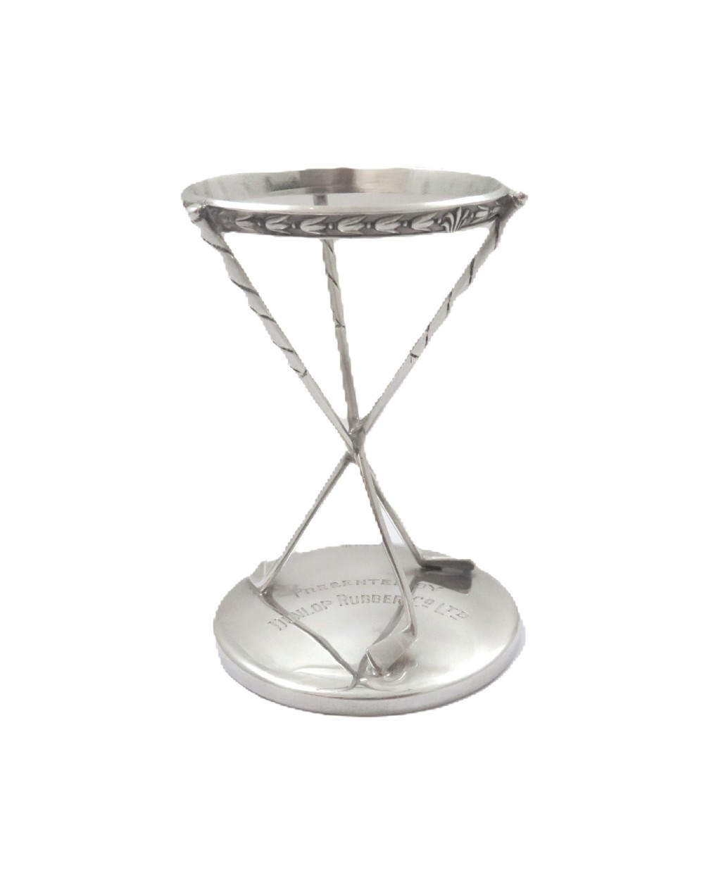 A sterling silver golf ball stand featuring three crossed golf club legs supported by a circular silver base holding a white golf ball. View VI