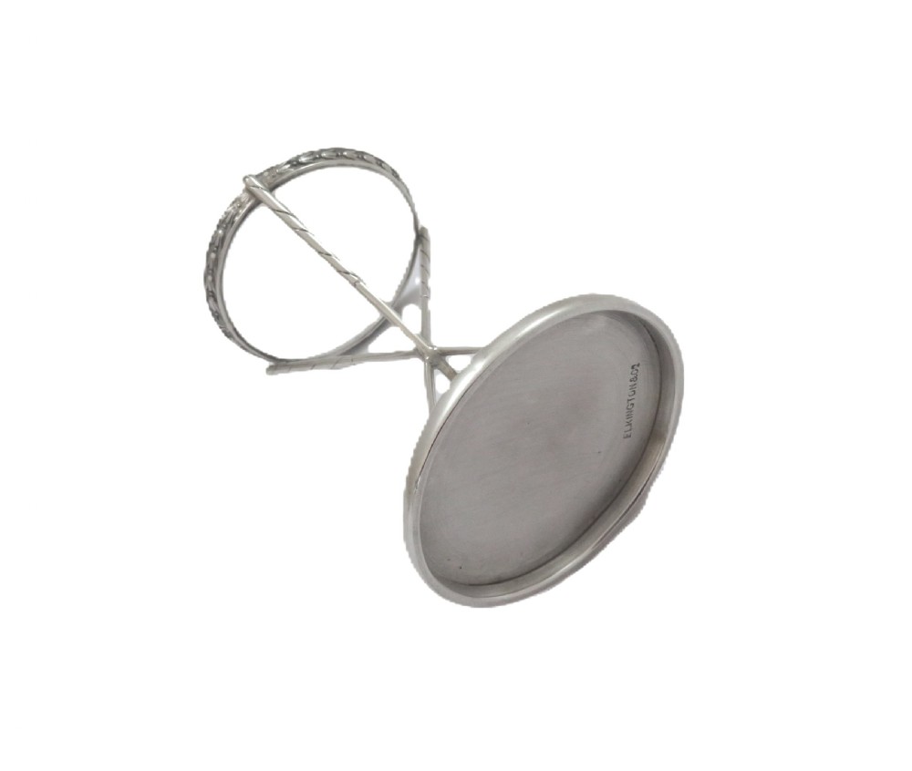 A sterling silver golf ball stand featuring three crossed golf club legs supported by a circular silver base holding a white golf ball. View VII