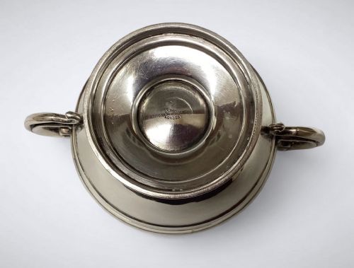 fig 1. An Edwardian sterling silver twin-handled bowl with high scroll handles and a stepped pedestal base.