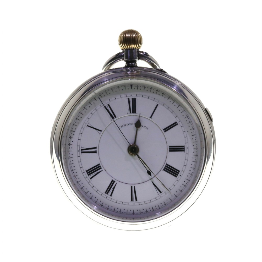An antique silver open-face chronograph pocket watch featuring a white enamel dial with black Roman numerals and a brass winding crown.