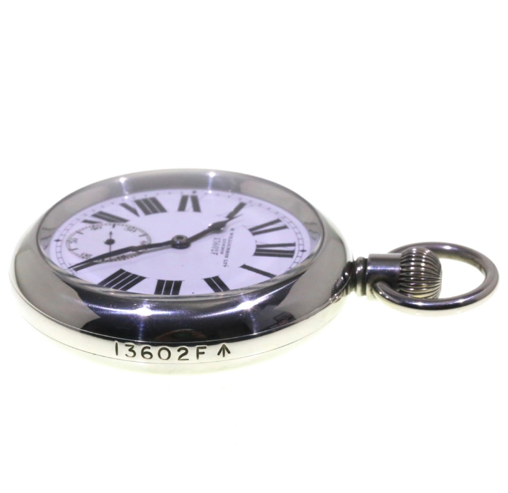 A circular silver-tone military keyless pocket watch with a white enamel dial, black Roman numerals, and a subsidiary seconds sub-dial. View IX
