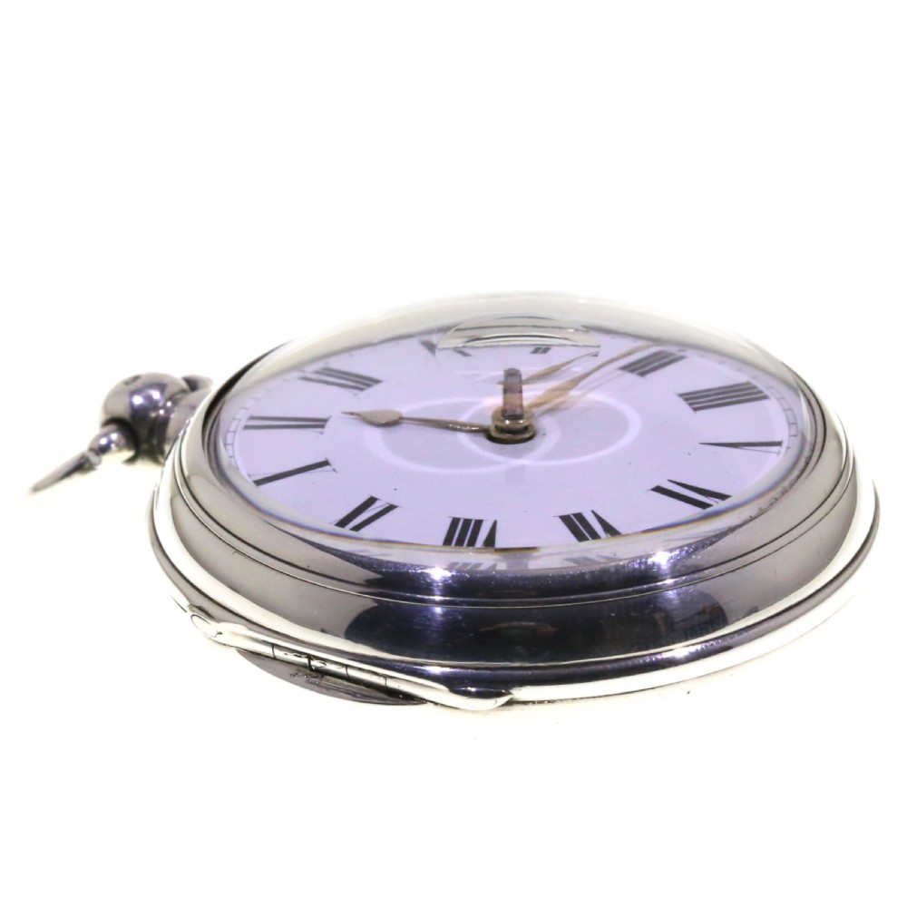 Victorian silver pair cased pocket watch featuring a white enamel dial with black Roman numerals and a silver pendant. View III