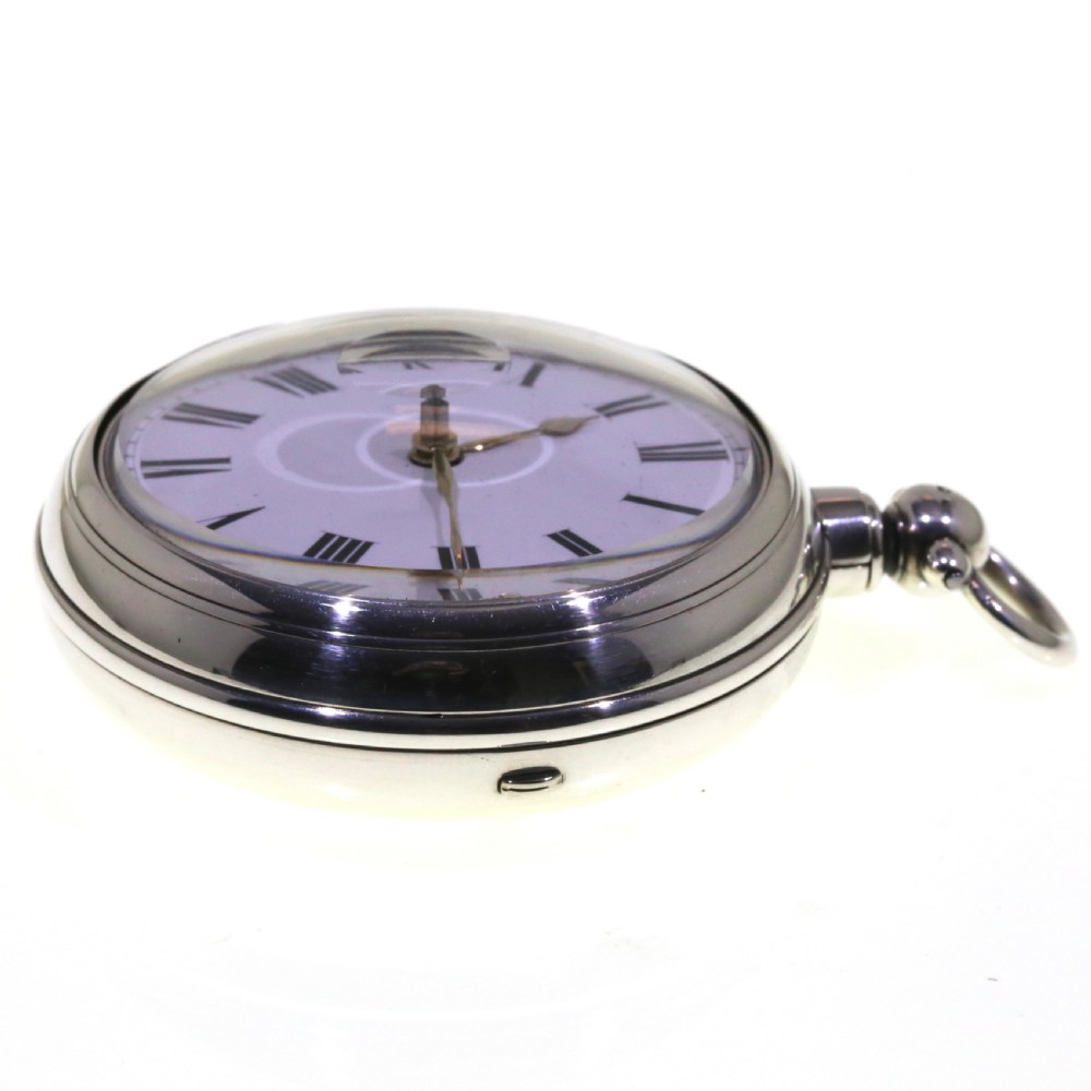 Victorian silver pair cased pocket watch featuring a white enamel dial with black Roman numerals and a silver pendant. View IV