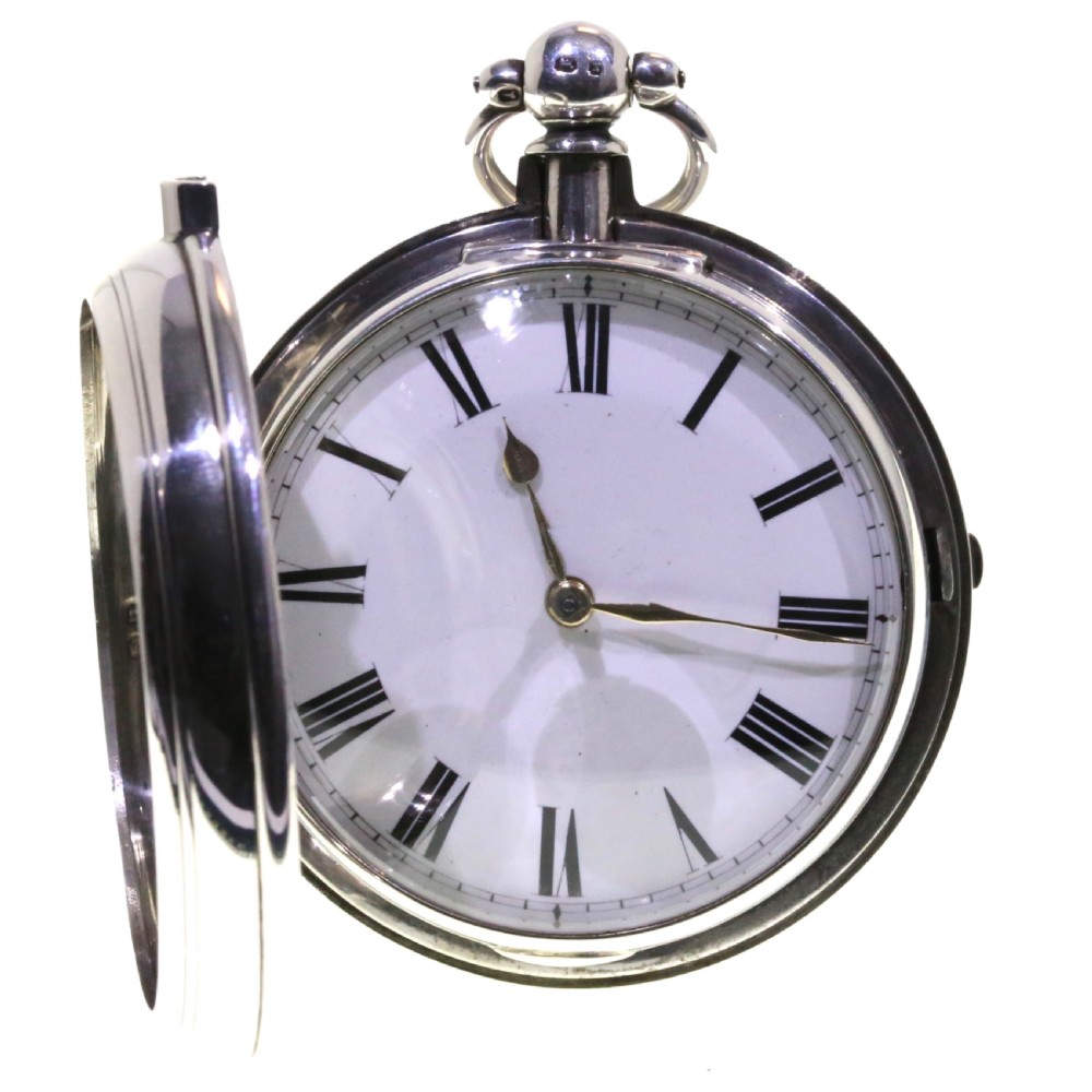 Victorian silver pair cased pocket watch featuring a white enamel dial with black Roman numerals and a silver pendant. View V