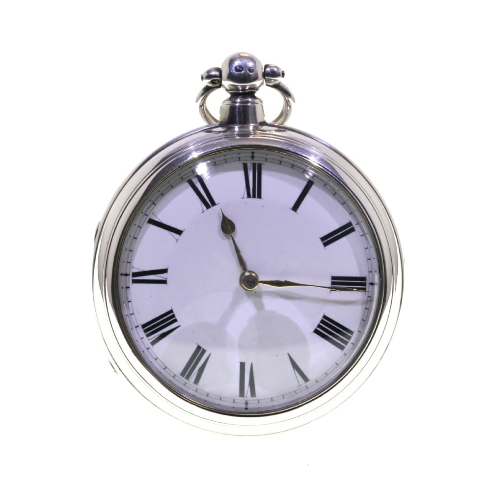 Victorian silver pair cased pocket watch featuring a white enamel dial with black Roman numerals and a silver pendant.