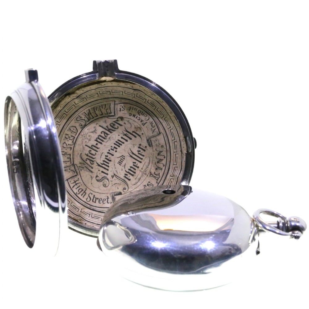 Victorian silver pair cased pocket watch featuring a white enamel dial with black Roman numerals and a silver pendant. View VII