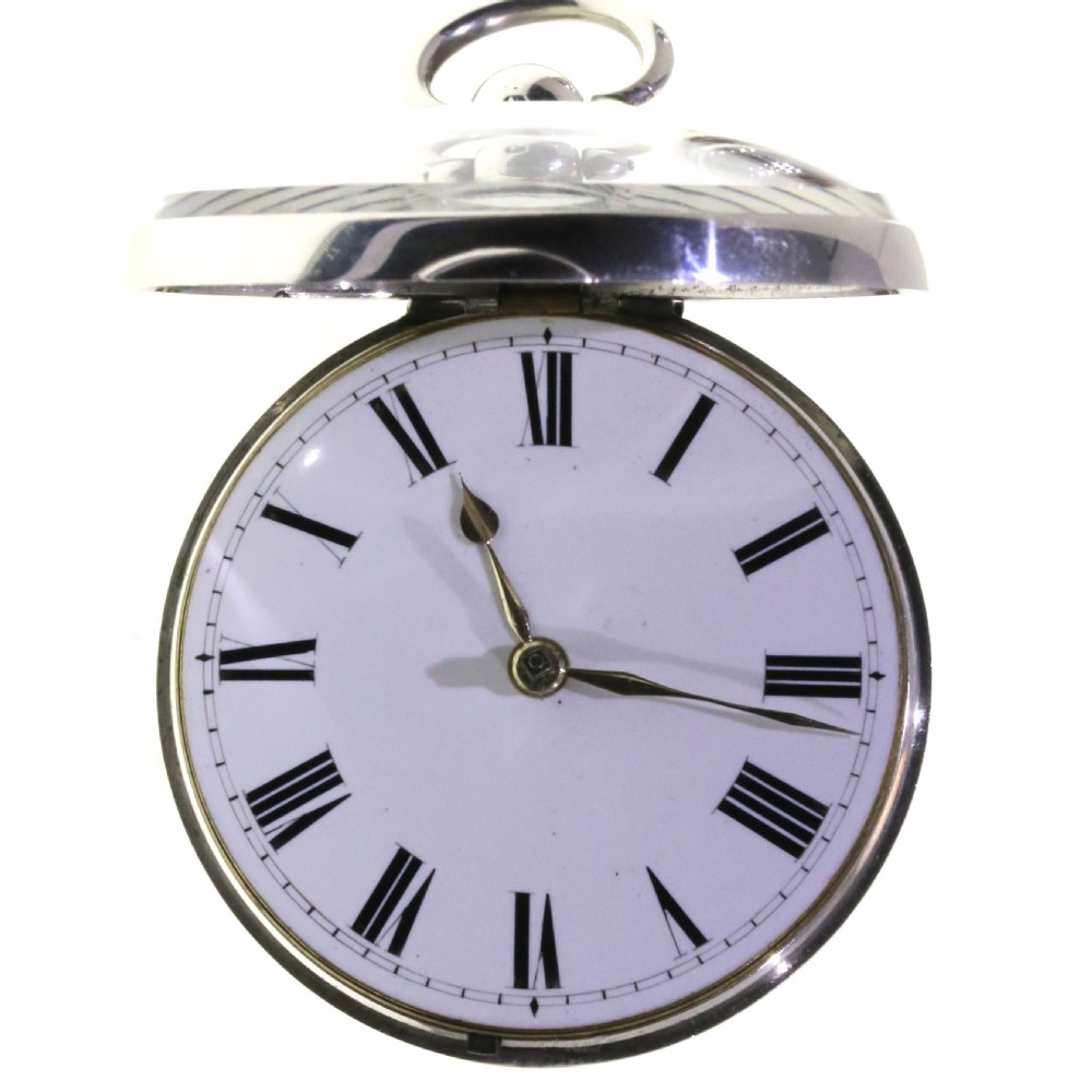 Victorian silver pair cased pocket watch featuring a white enamel dial with black Roman numerals and a silver pendant. View VIII