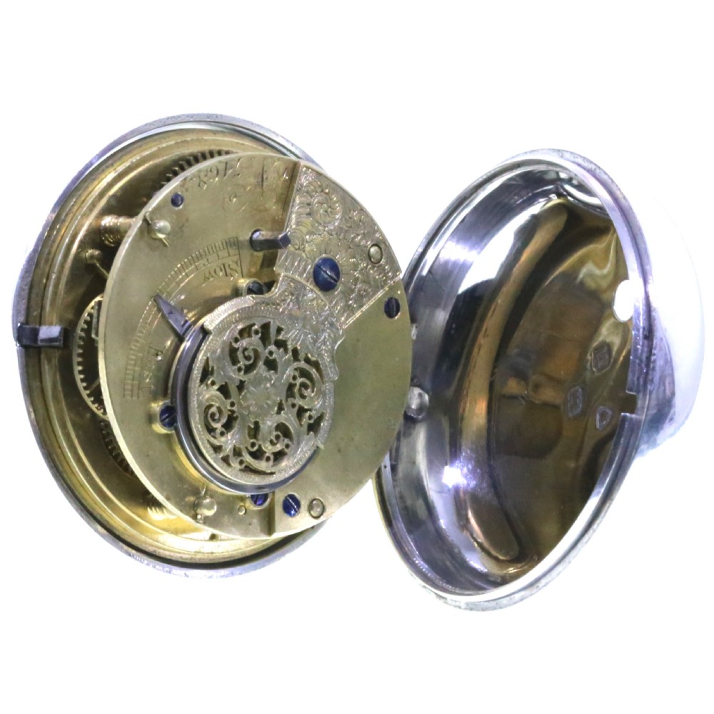 Victorian silver pair cased pocket watch featuring a white enamel dial with black Roman numerals and a silver pendant. View IX