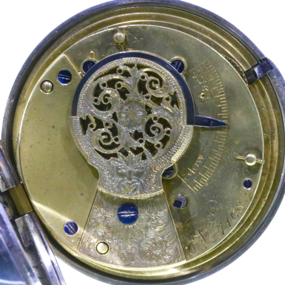 Victorian silver pair cased pocket watch featuring a white enamel dial with black Roman numerals and a silver pendant. View XIII