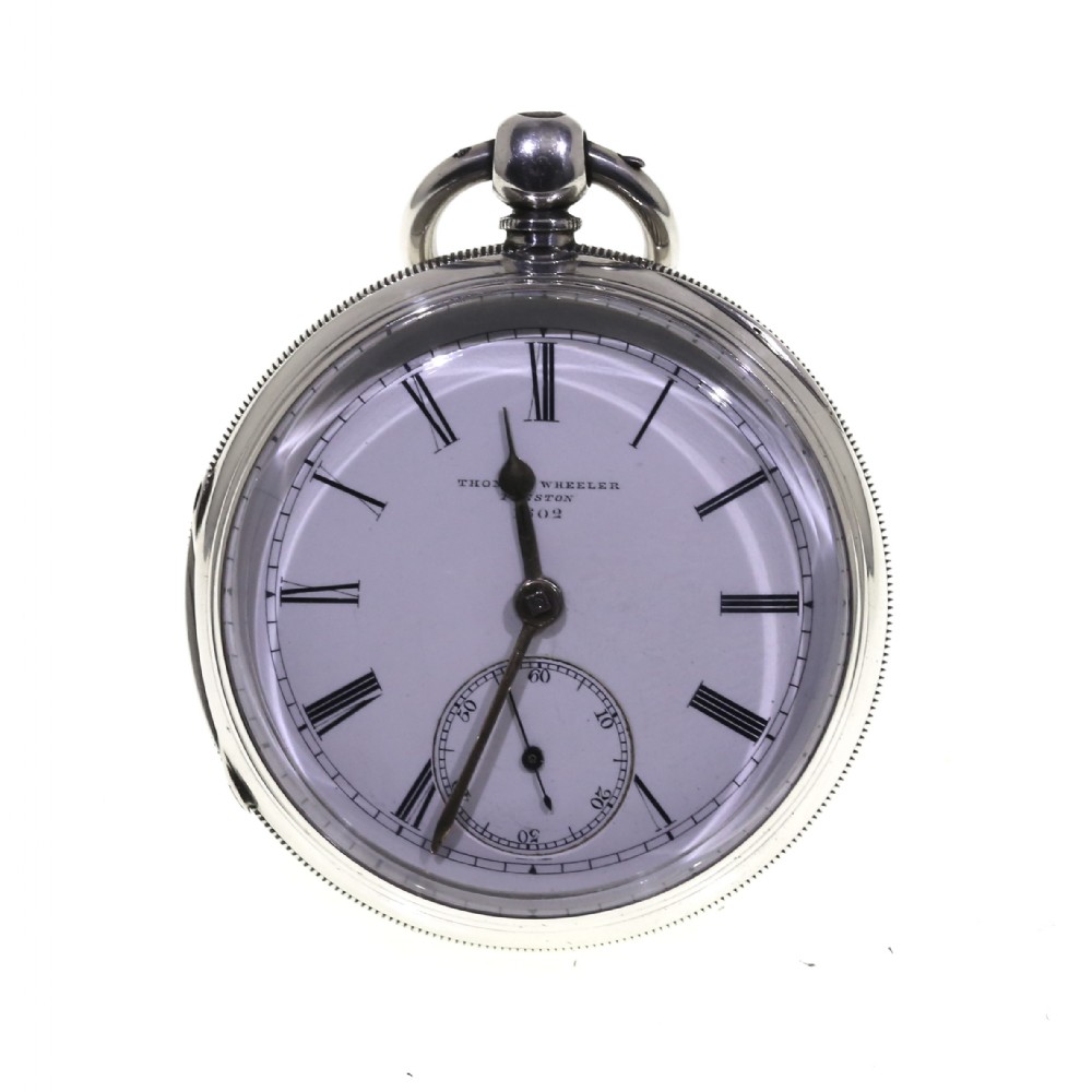 A Victorian silver pocket watch displaying a white enamel dial with black Roman numerals, dark steel hands, a subsidiary seconds dial, and an attached silver hanging loop.