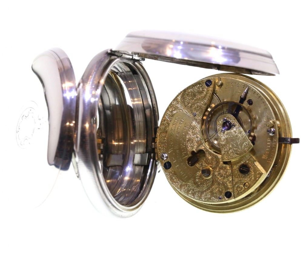 A Victorian silver pocket watch displaying a white enamel dial with black Roman numerals, dark steel hands, a subsidiary seconds dial, and an attached silver hanging loop. View IV