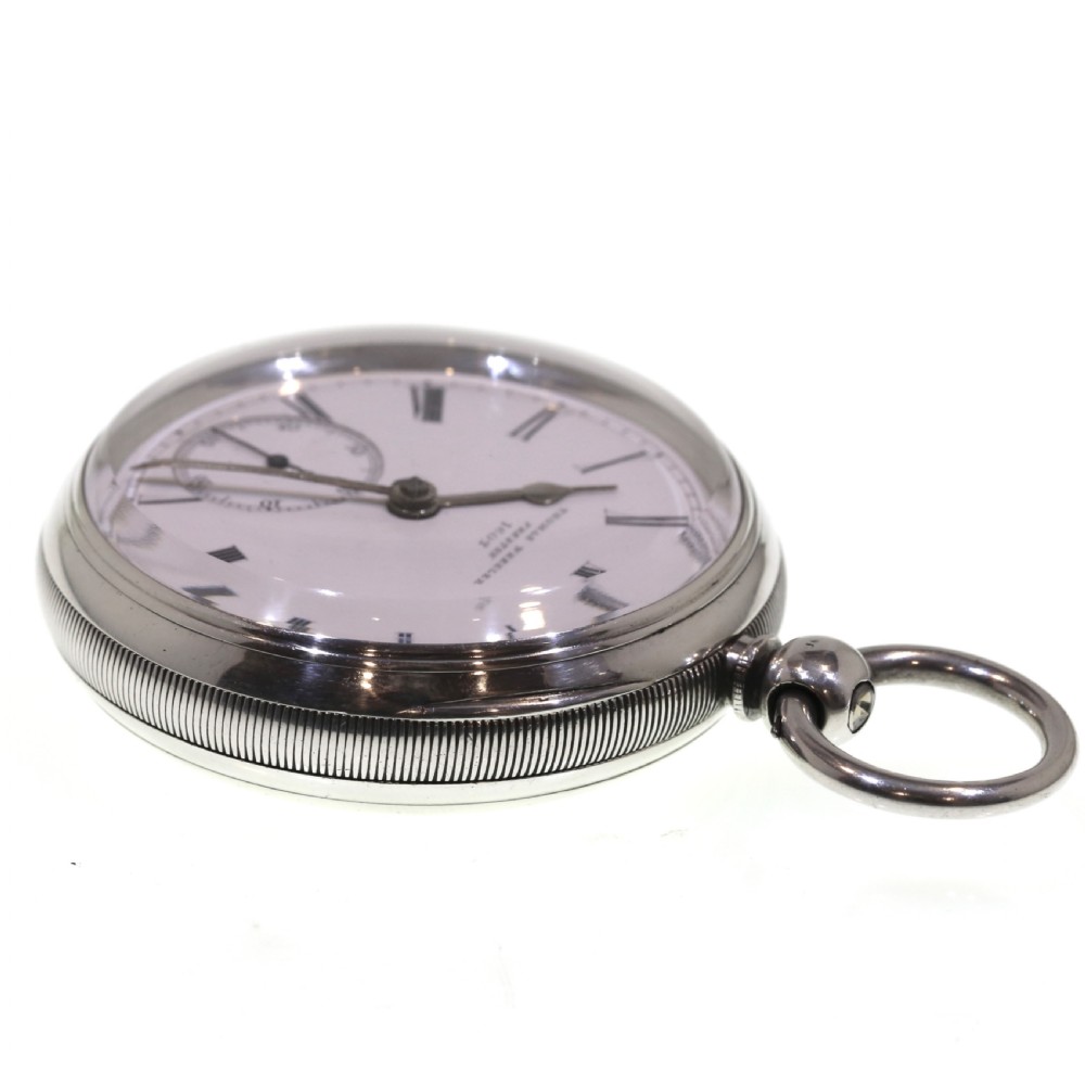 A Victorian silver pocket watch displaying a white enamel dial with black Roman numerals, dark steel hands, a subsidiary seconds dial, and an attached silver hanging loop. View X