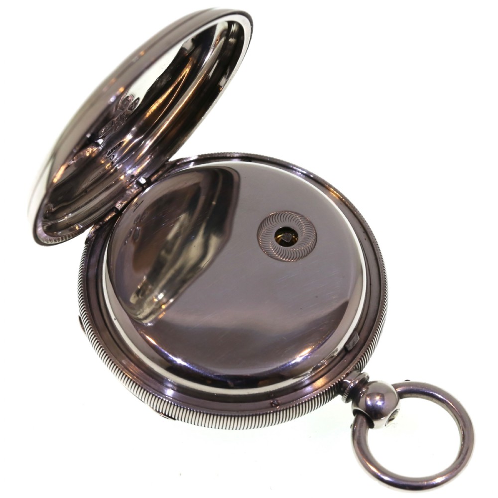 A Victorian silver pocket watch displaying a white enamel dial with black Roman numerals, dark steel hands, a subsidiary seconds dial, and an attached silver hanging loop. View XIII