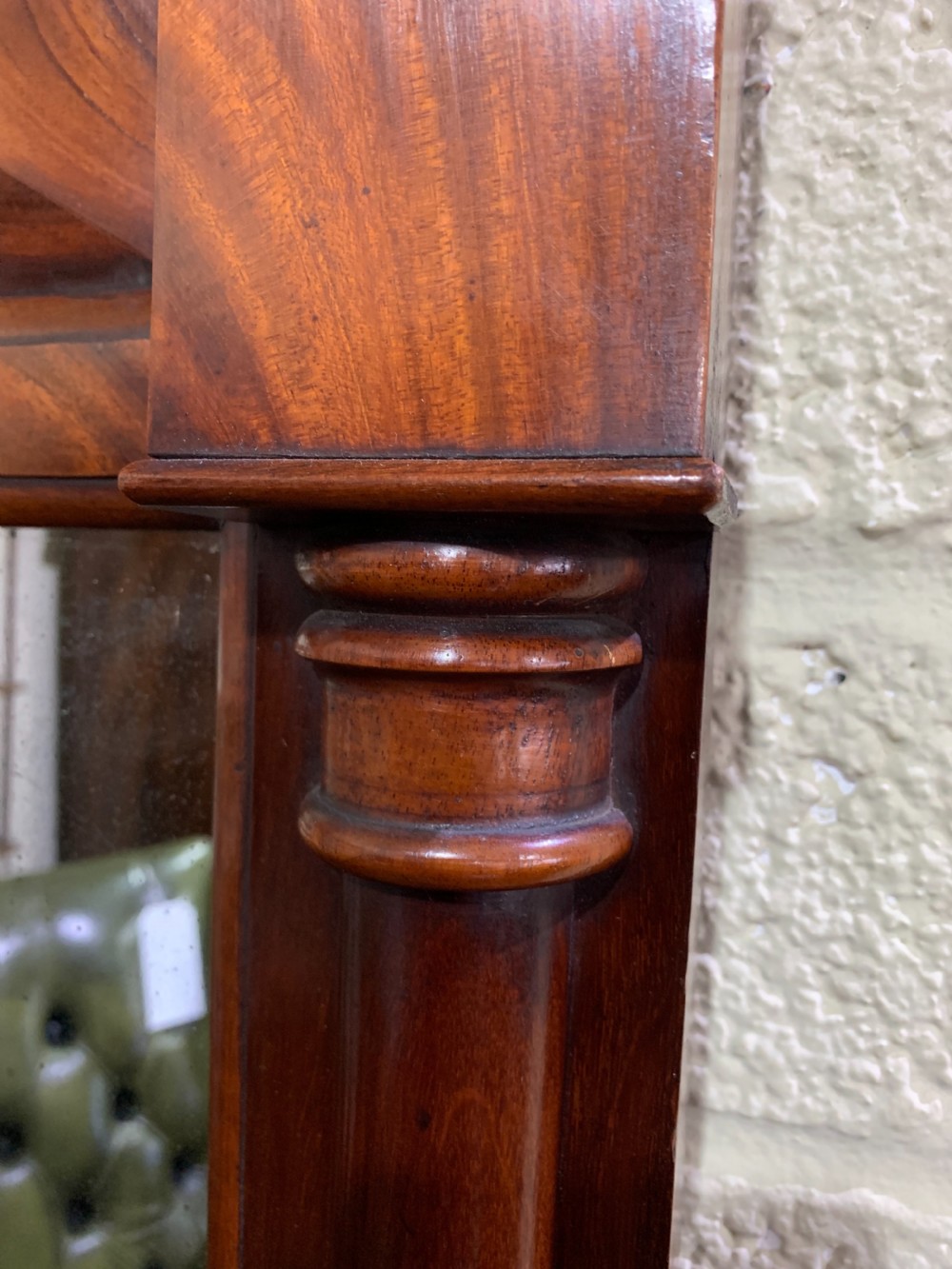 A rectangular antique mahogany wall mirror featuring a projected upper cornice, a faceted flame mahogany top panel, and side columns. View II