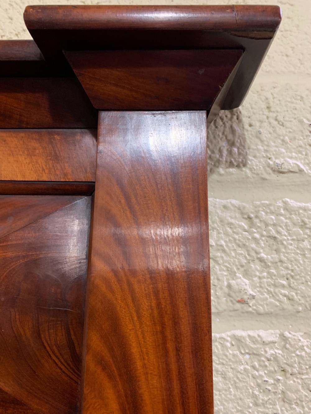 A rectangular antique mahogany wall mirror featuring a projected upper cornice, a faceted flame mahogany top panel, and side columns. View III