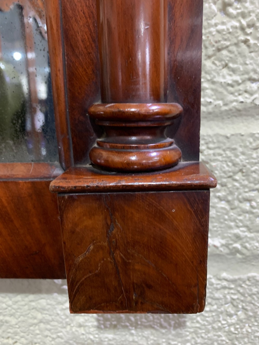 A rectangular antique mahogany wall mirror featuring a projected upper cornice, a faceted flame mahogany top panel, and side columns. View V