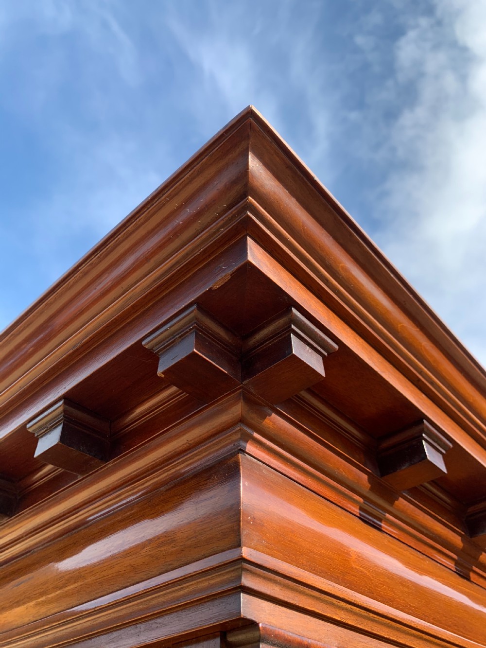 A tall Victorian mahogany bookcase with two upper glazed doors, two carved drawers, and lower carved cupboard doors. View VII