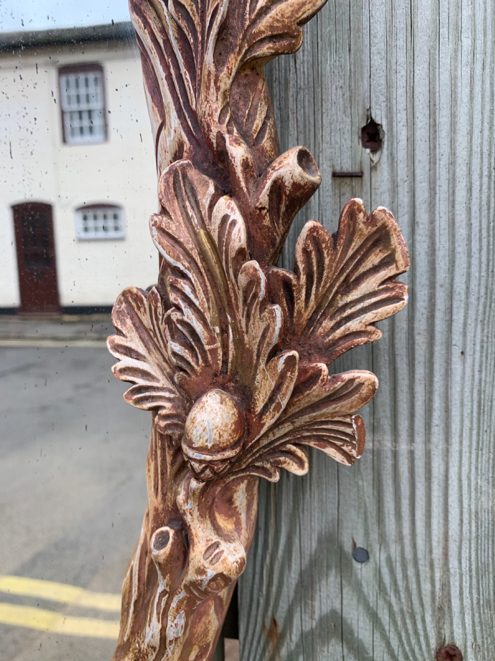 A pair of oval wall mirrors featuring ornate carved wooden frames with oak leaf motifs and ribbon crests in a painted finish. View IV