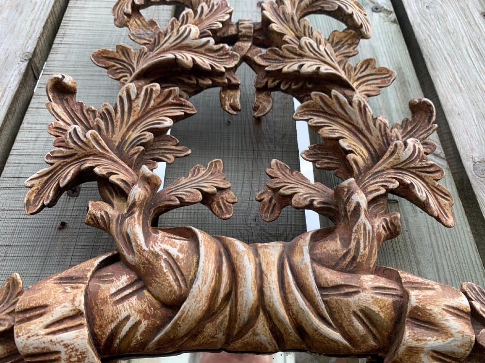 A pair of oval wall mirrors featuring ornate carved wooden frames with oak leaf motifs and ribbon crests in a painted finish. View VI