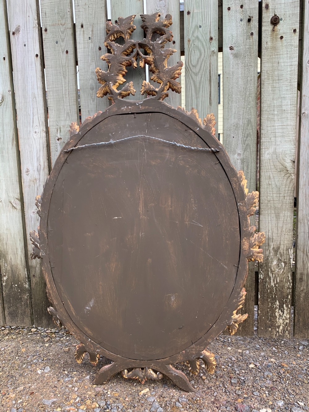 A pair of oval wall mirrors featuring ornate carved wooden frames with oak leaf motifs and ribbon crests in a painted finish. View VIII