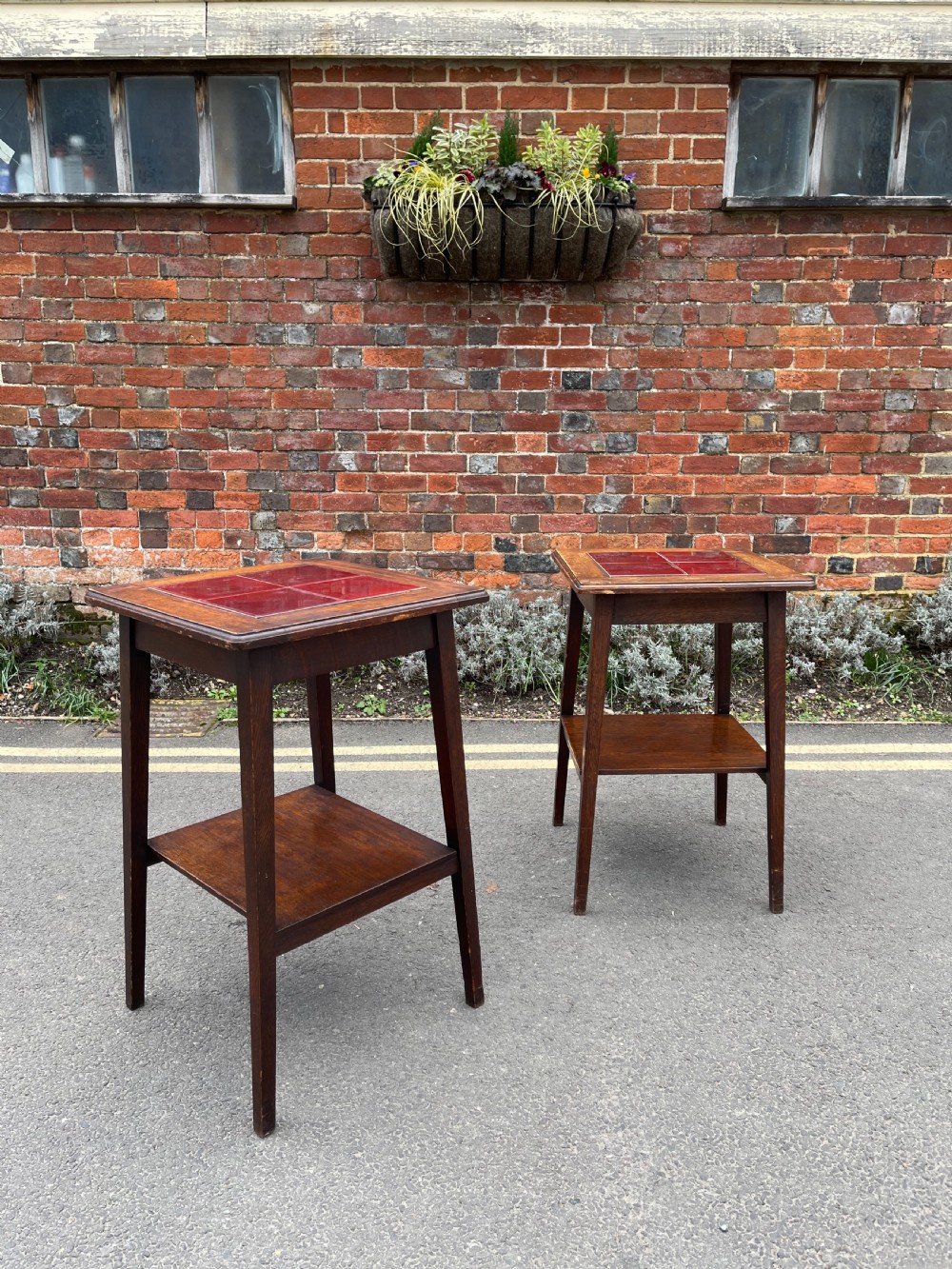 Pair of arts and crafts influenced tile topped tables 