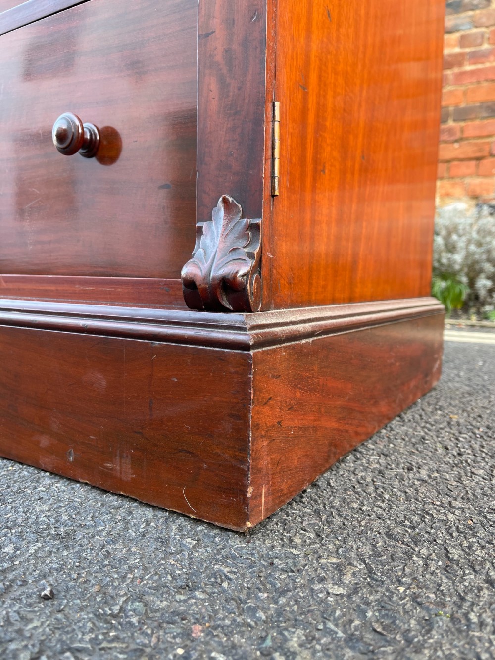 A tall Victorian mahogany Wellington chest featuring seven graduated drawers with turned wooden knobs, carved side corbels, and a side locking pilaster. View II