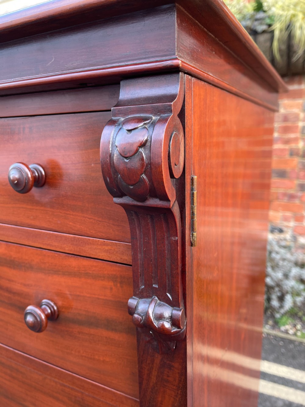 A tall Victorian mahogany Wellington chest featuring seven graduated drawers with turned wooden knobs, carved side corbels, and a side locking pilaster. View XII