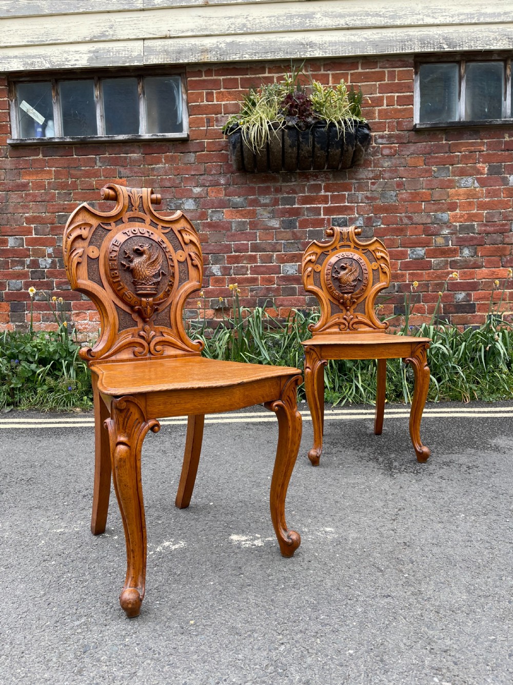 Pair of early Victorian oak hall chairs 