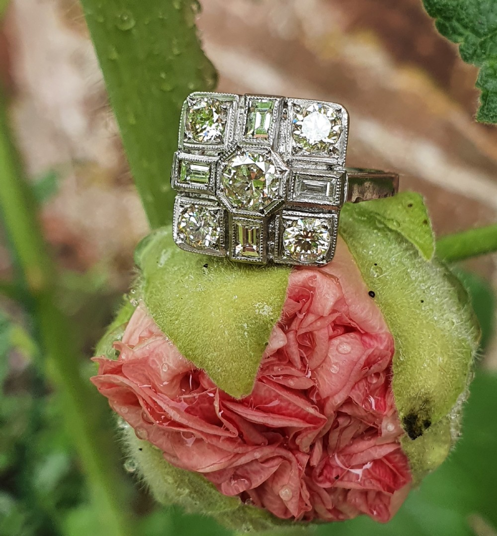 An Art Deco platinum cocktail ring featuring a geometric rectangular plaque setting filled with round and rectangular diamonds and detailed millegrain edging. View VIII