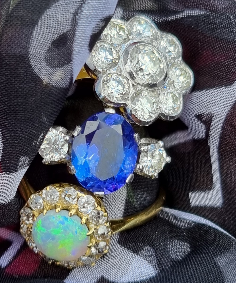 An 18ct yellow gold ring featuring a platinum-set floral head diamond cluster with a central round diamond encircled by eight surrounding diamonds. View XI
