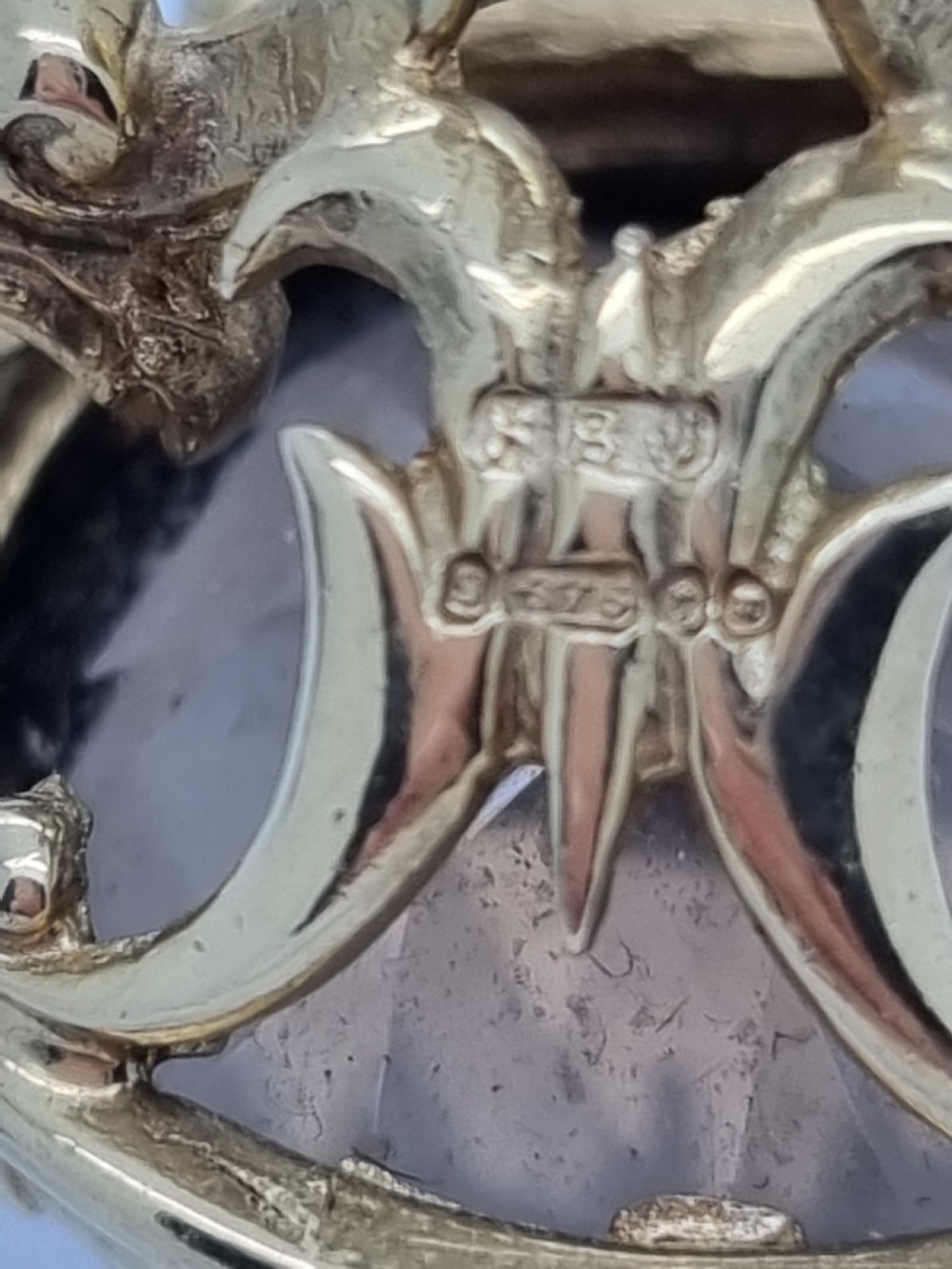 An ornate 9ct gold watch fob pendant set with a large faceted smokey quartz gemstone and detailed scrollwork frame. View VIII