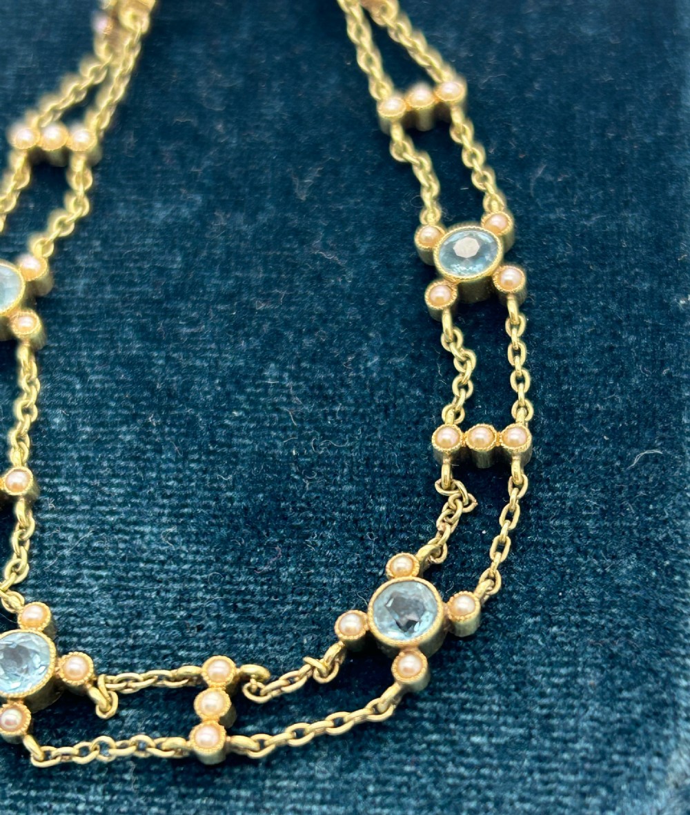 A late Victorian 15ct gold double trace chain bracelet set with round faceted aquamarines and split seed pearls. View XI