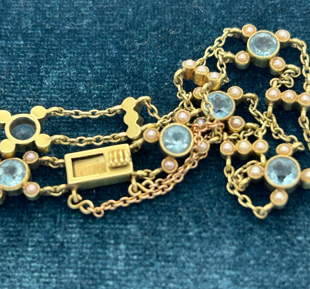 A late Victorian 15ct gold double trace chain bracelet set with round faceted aquamarines and split seed pearls. View XII