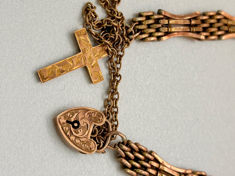 Victorian 9ct rose gold gate link bracelet featuring an engraved heart padlock clasp, safety chain, and cross charm. View II