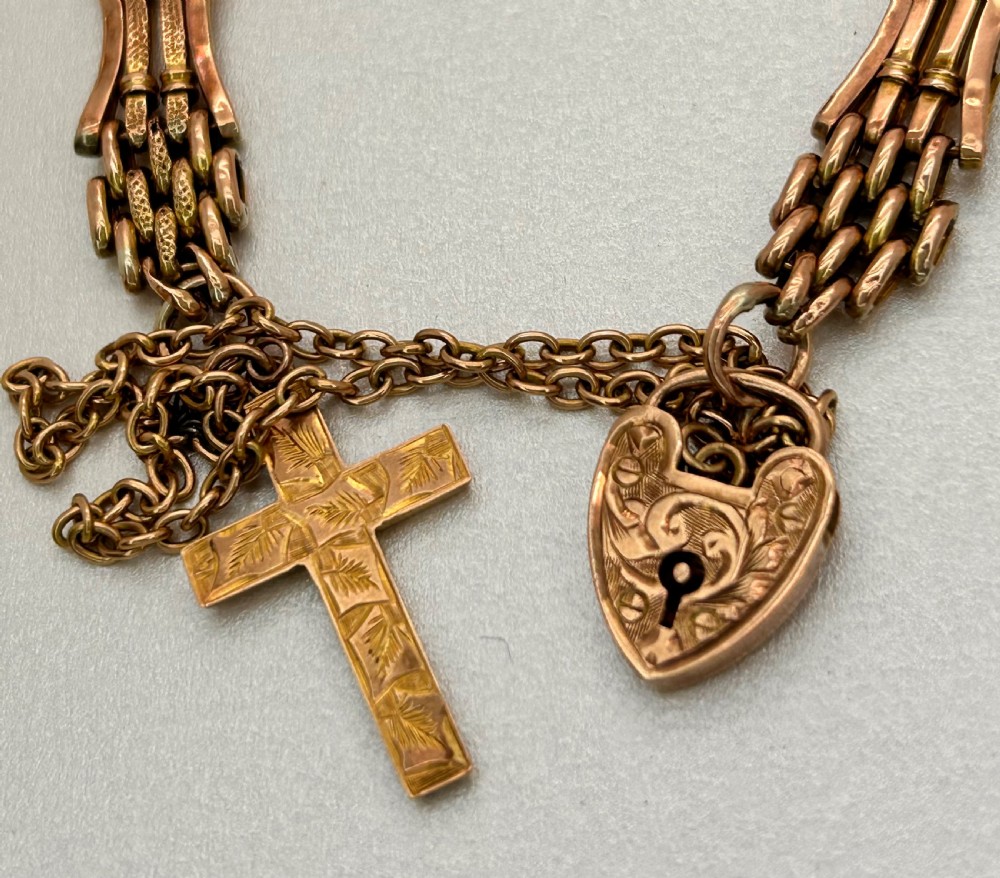 Victorian 9ct rose gold gate link bracelet featuring an engraved heart padlock clasp, safety chain, and cross charm. View III