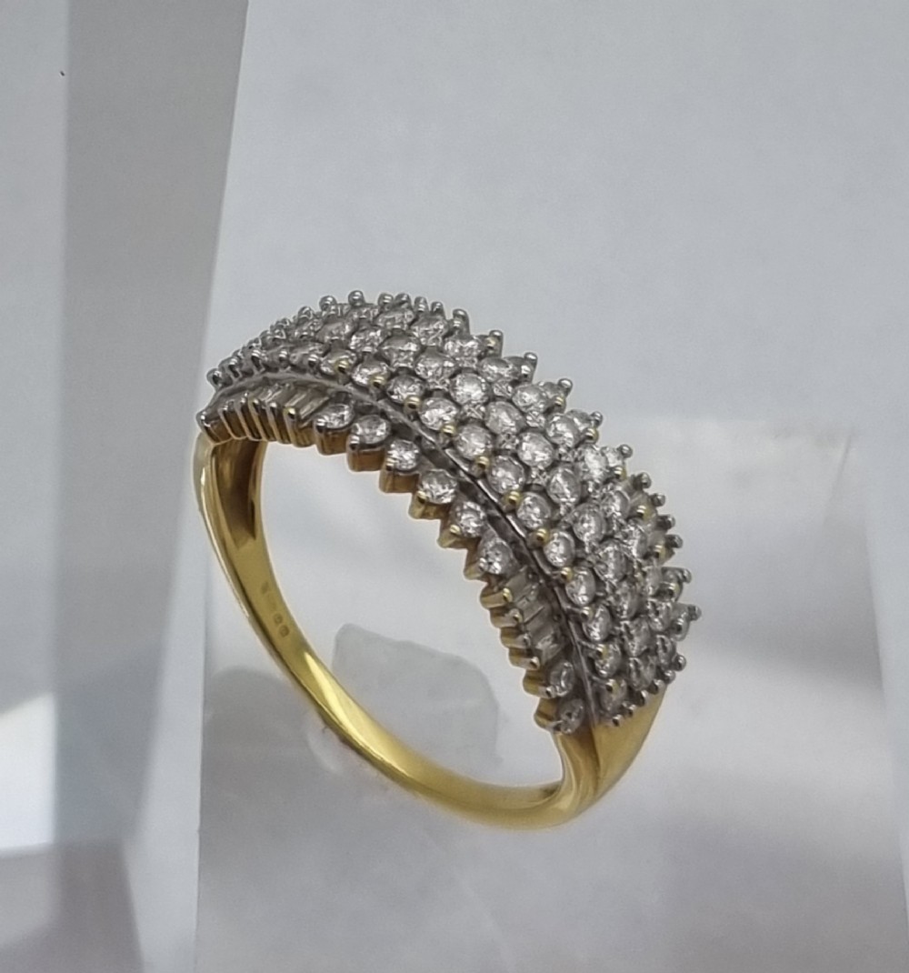 An 18ct yellow gold dress ring set with multiple rows of round brilliant diamonds across the upper band. View II