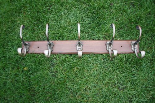 Five Edwardian Coat-hooks Mounted on Walnut