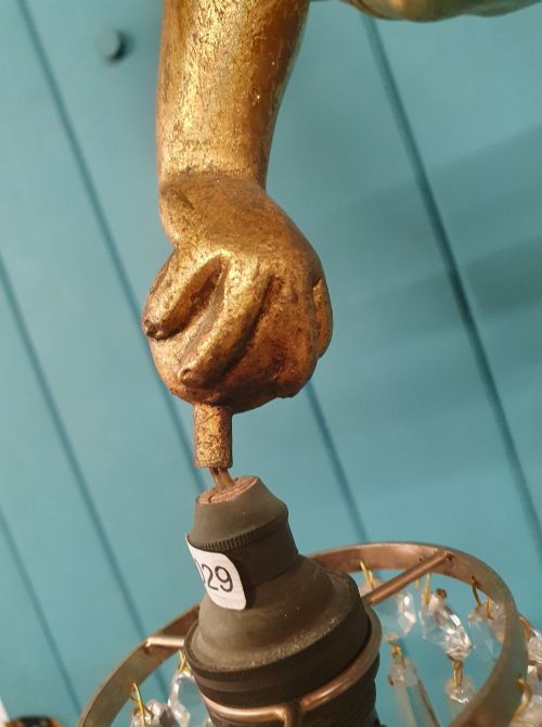 fig 1. An antique gilt spelter flying winged cherub suspended from a chain, holding two light sockets decorated with cut glass crystal drops.